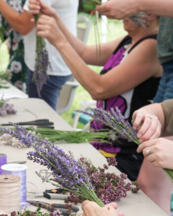 group of people assembling lavender crafted items