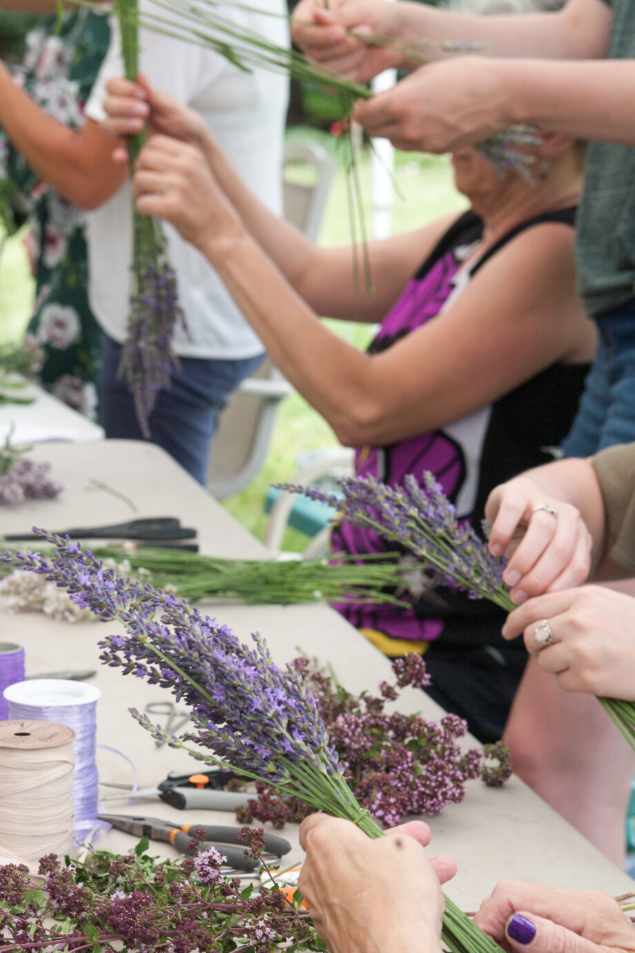group of people assembling lavender crafted items