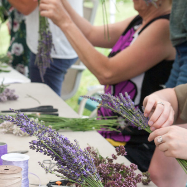 group of people assembling lavender crafted items